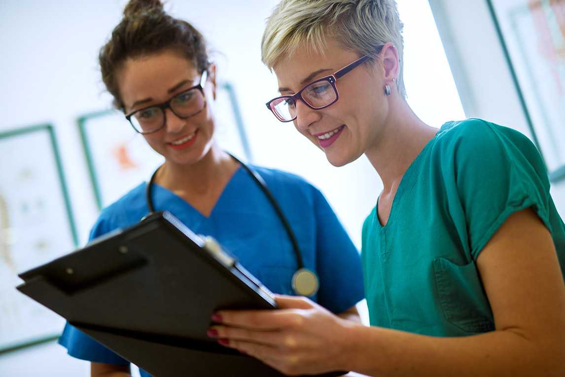 Medical professionals reviewing a chart.