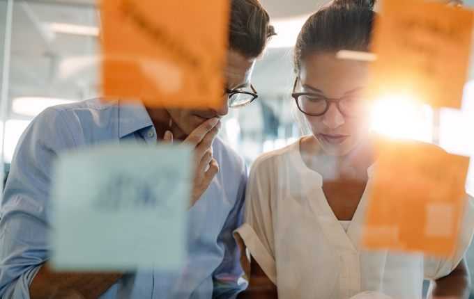 Two healthcare professionals look over something together.
