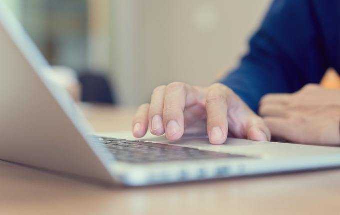 A person types on a computer.